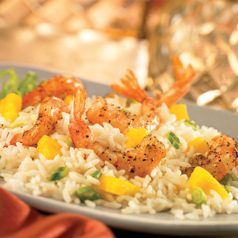 Side view of Spiced Shrimp sitting on a bed of Coconut-Pineapple Rice