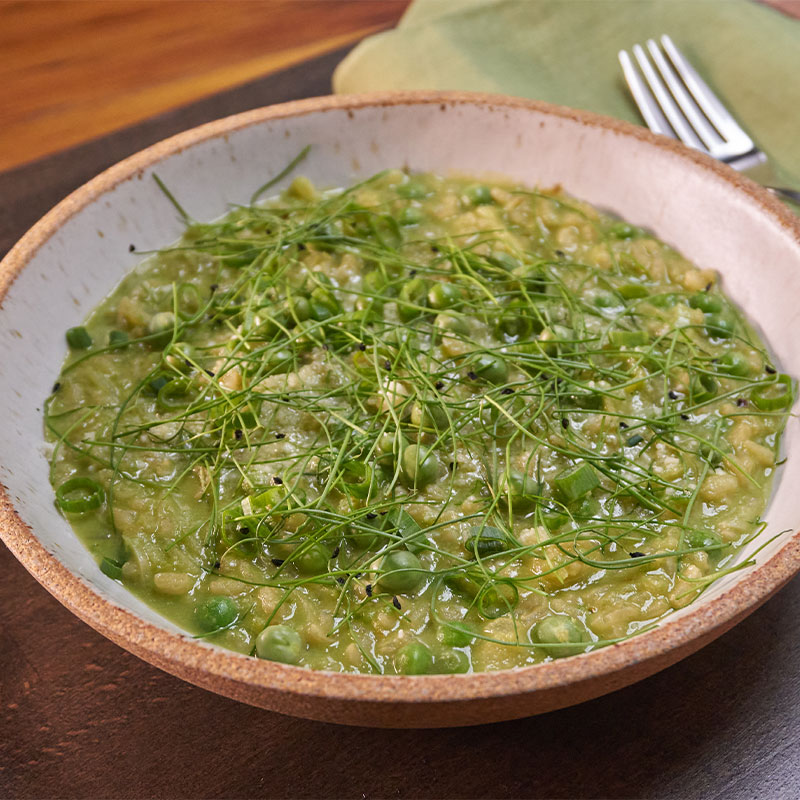 Overhead shot of a bowl of Spring Onion and Pea Risotto.