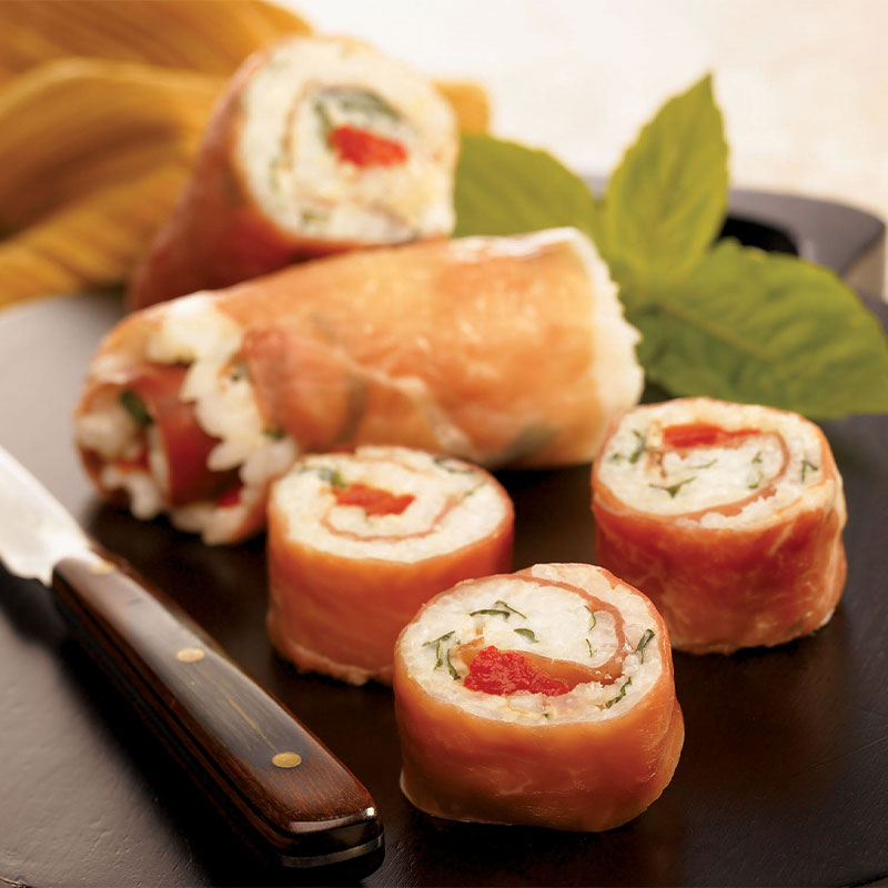 Prosciutto wrapped around a rice mixture to form a roll and cut into sushi-sized pieces.  