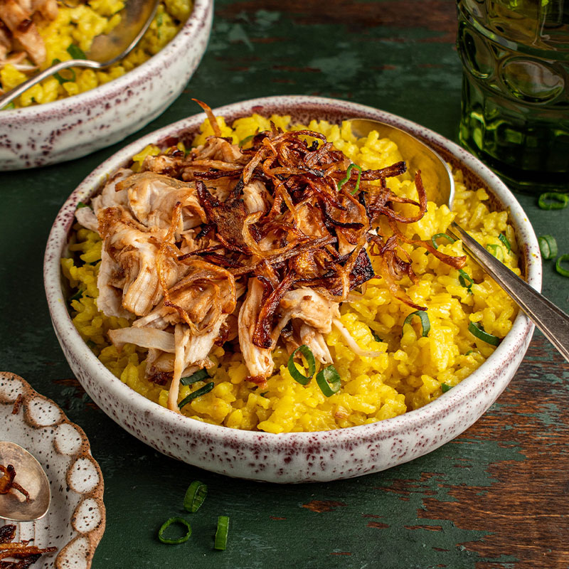 Zoomed in image of a serving of Taiwanese Turkey Yogurt Scallion Rice in a white bowl.