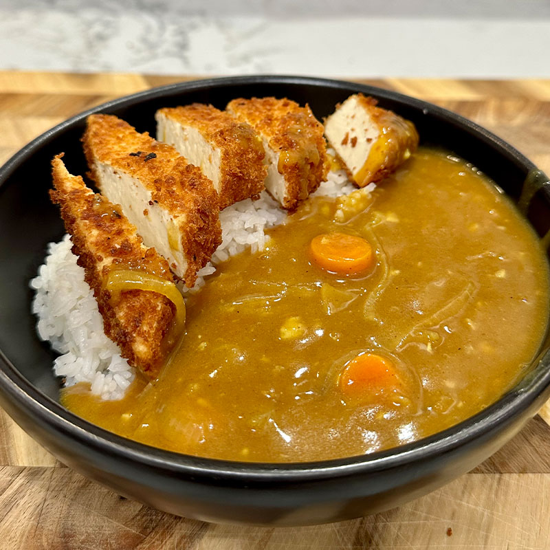 Tofu Catsu Curry A zoomed in image of a bowl of Tofu Catsu Curry.