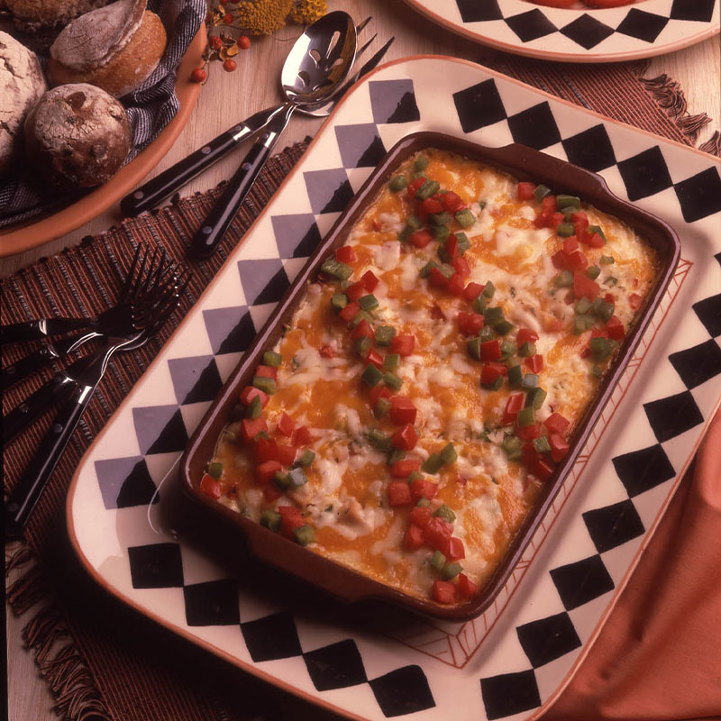 Turkey and Rice Quiche Overhead shot of Turkey and Rice Quiche with melted cheese and diced peppers.