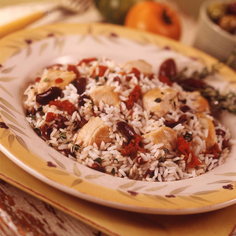 Close up image of a bowl of Wild Thyme Summer Salad with chicken pieces and black beans exposed.