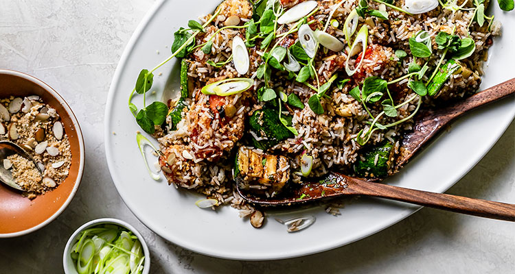 Overhead view of Herby Rice Salad with Vegetables on a white serving platter.