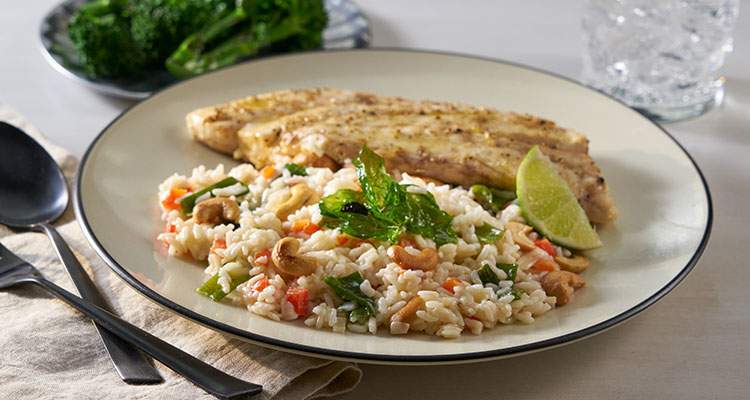 Side view of Miso Snapper Coconut Rice Pilaf on a white plate.