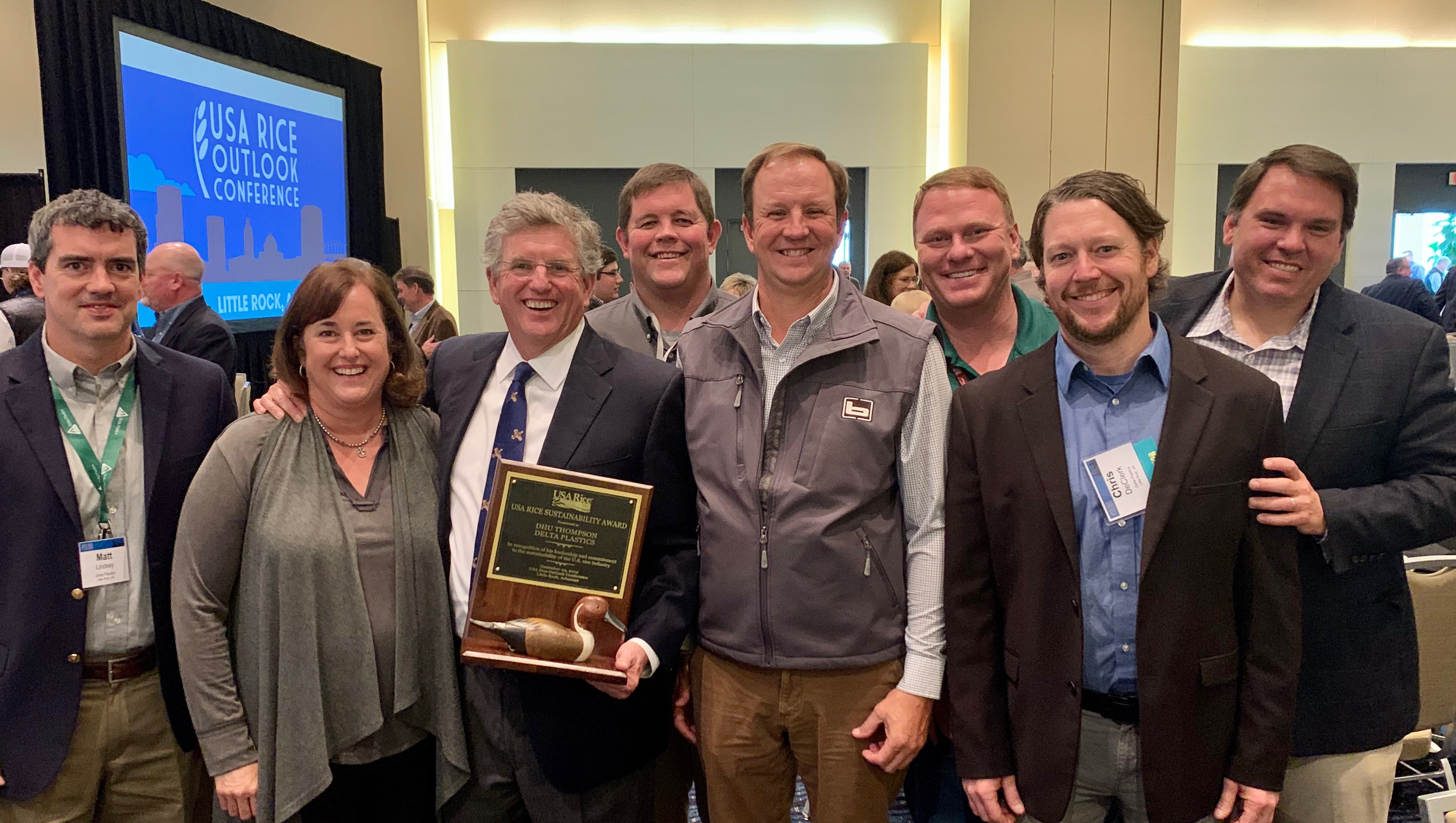 COMM-Delta Plastics Sustainability Award-191217 Group shot of people holding award plaque with duck decoy