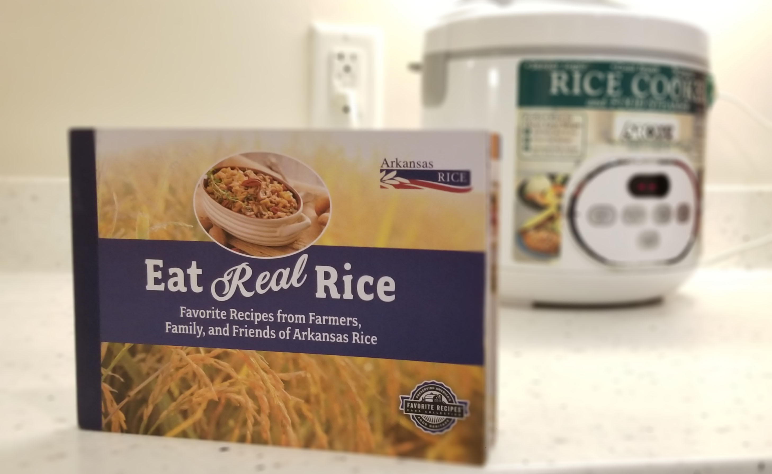 Eat Real Rice Cookbook on counter with rice cooker in background