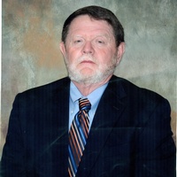 Jimmy Richard, white man in dark suit with dark hair and a white beard