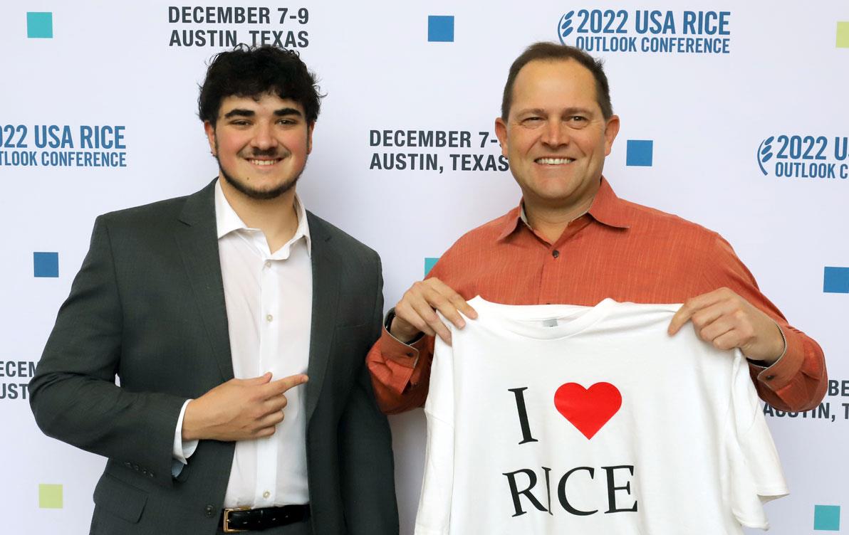 2022-NRM-Scholly-Winner-Cole-Skelley-presents Chris-Crutchfield with "I Heart Rice" t-shirt