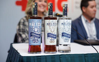 2025 Outlook, JT Meleck Whiskey bottles lined up on table