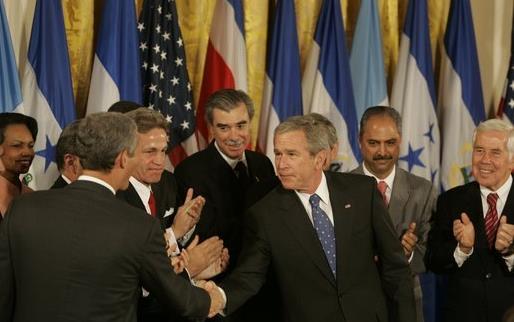 World leaders including Geo W. Bush stand in front of national flags