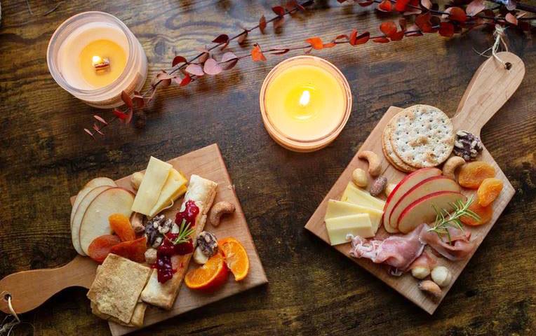 Overhead photo of charcuterie boards and candles