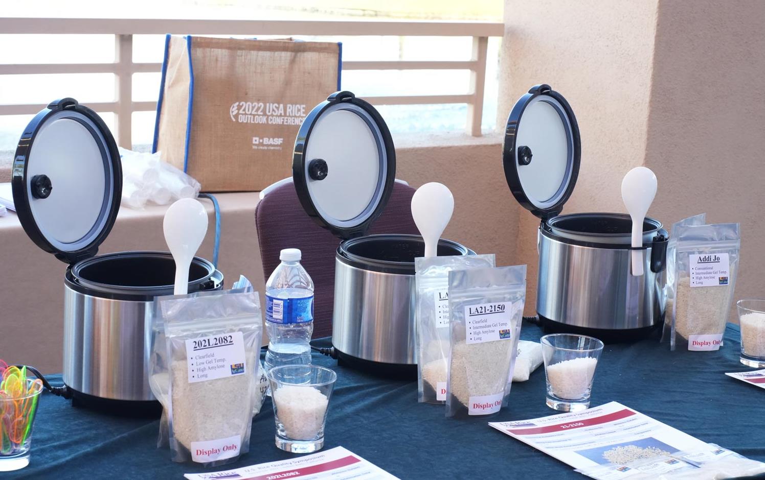 Cookers-at-Quality-Symposium sitting on table with rice samples and handouts
