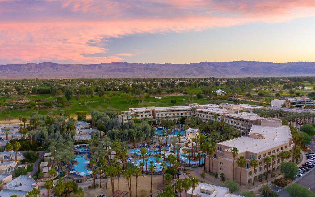 Aerial photo of Hyatt Regency, Indian Wells, pink sky at sunset & mountains in background