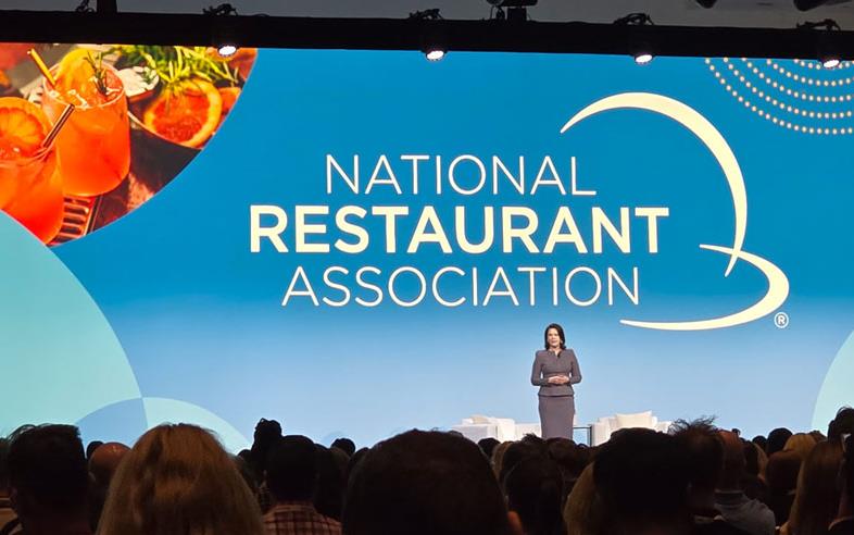 NRA-Main-Stage with person standing in front of large presentation screen