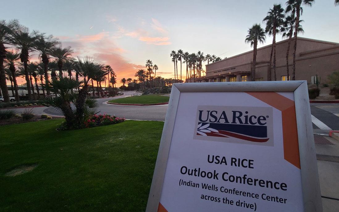 Outlook-Conference-signage-outside-venue at sunset with palm trees silhouetted in background