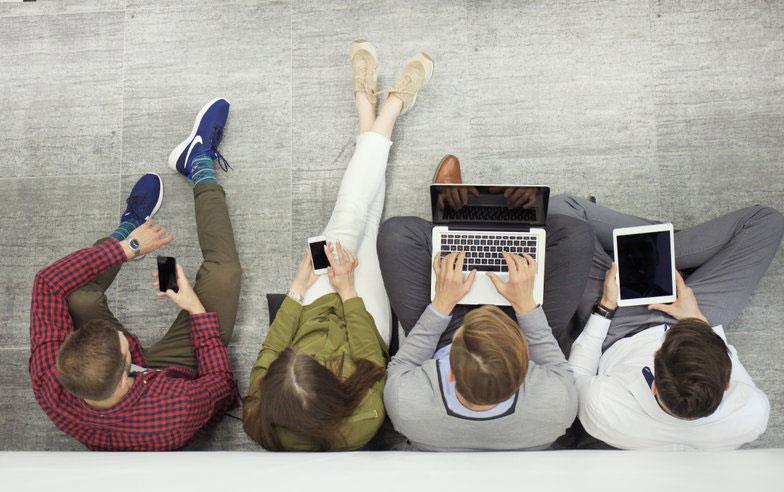 Overhead-shot-of-people-reading-on-phones-&-tablets