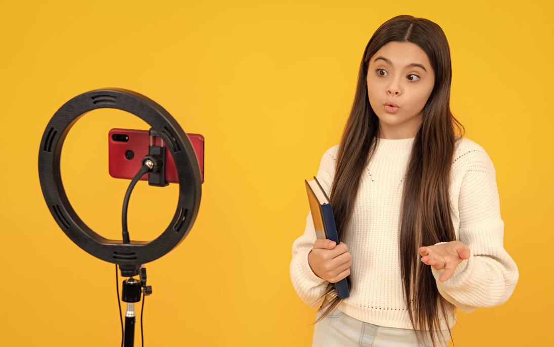 Female student-posing-for-phone-mounted-on-ring-light
