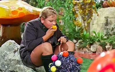 Augustus Gloop gorging on food, photo from Willie Wonka & the Chocolate Factory film