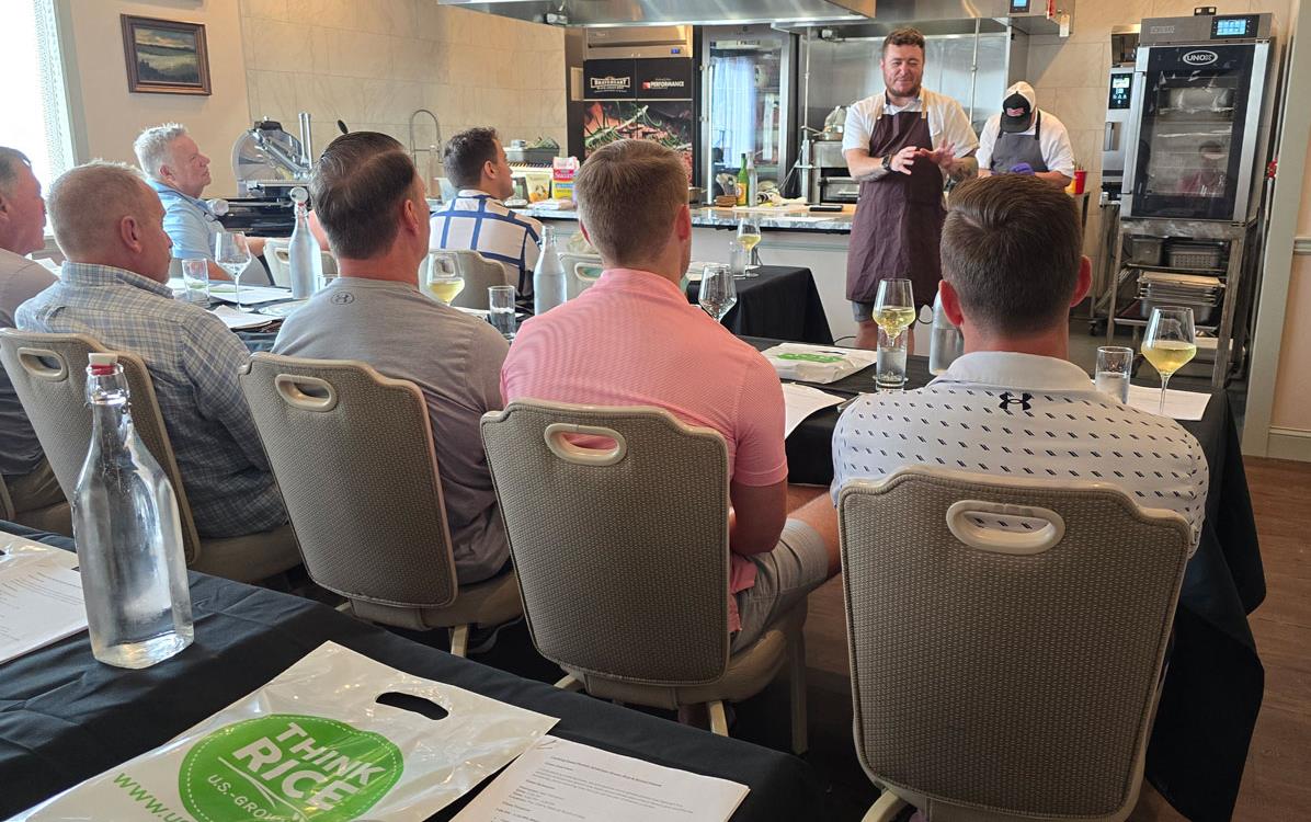 Chef Hari Cameron conducts rice cooking class in front of audience of men seated in chairs