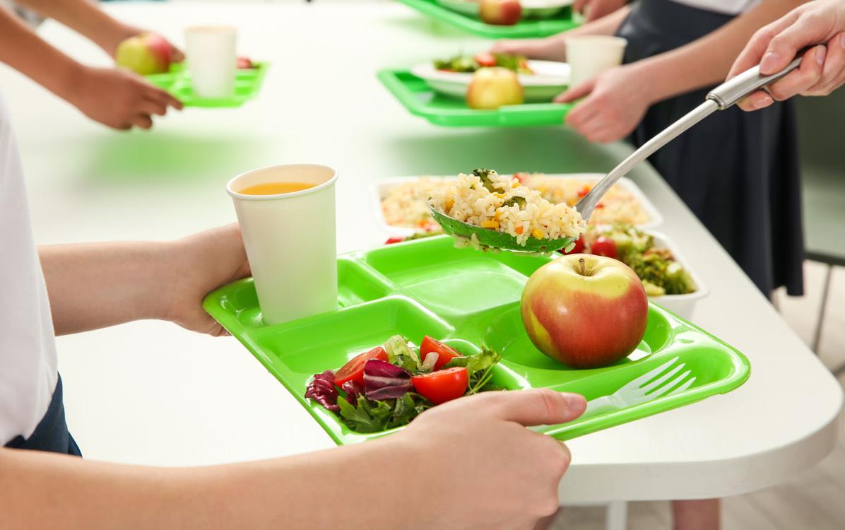 Serving rice on bright green school lunch tray