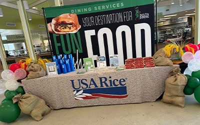 USAR Booth at Delta State with poster, balloons, table filled with giveaways