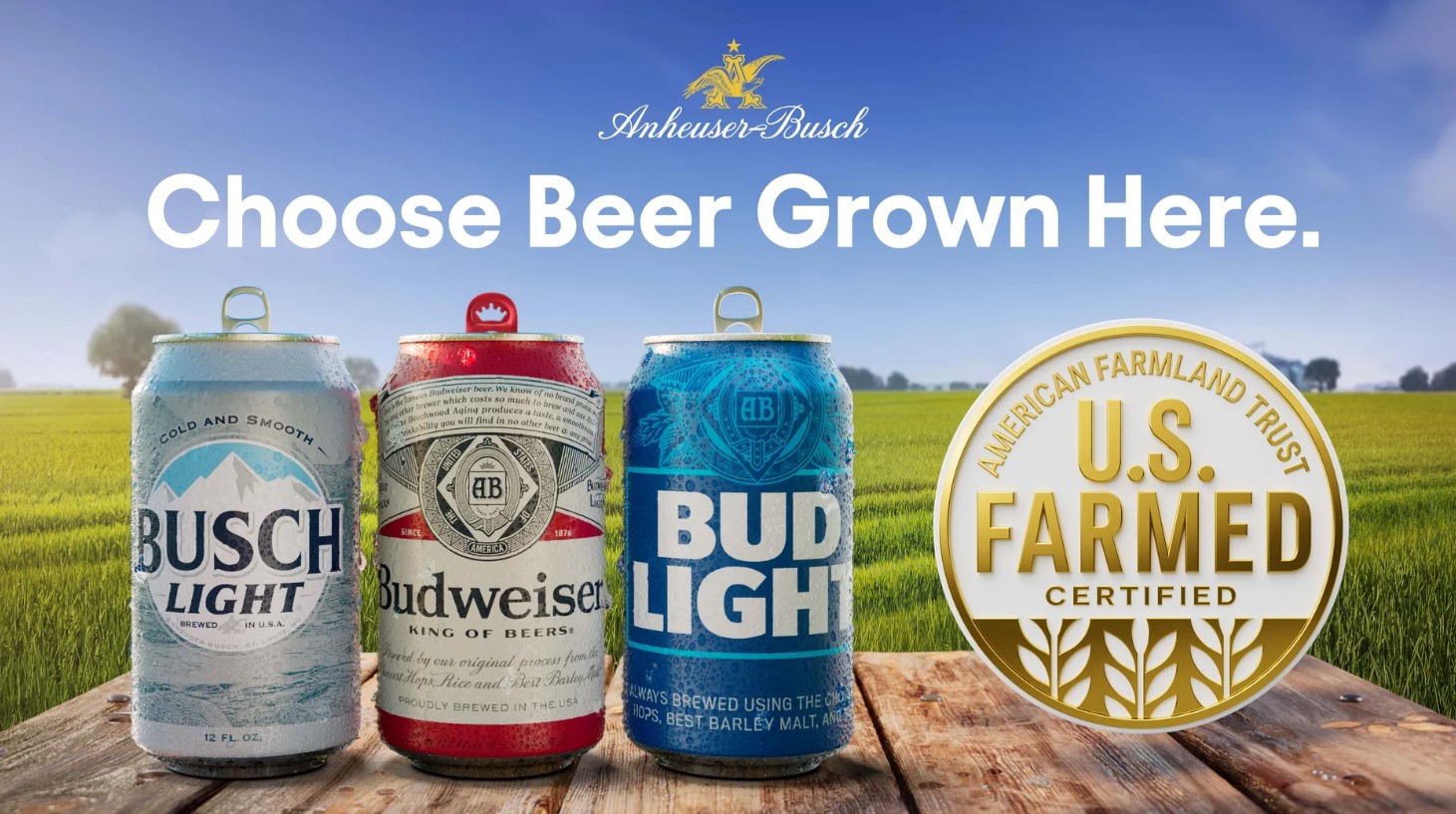 AB Choose Beer Grown Here graphic shows three beers in a line up plus US Farmed Certified logo on table in front of green rice field