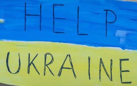 Blue and yellow "Help Ukraine" sign