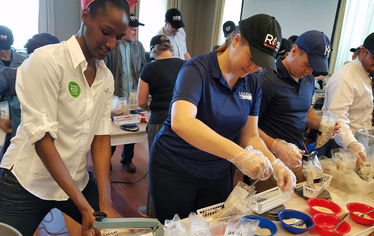 People assembling food aid packages