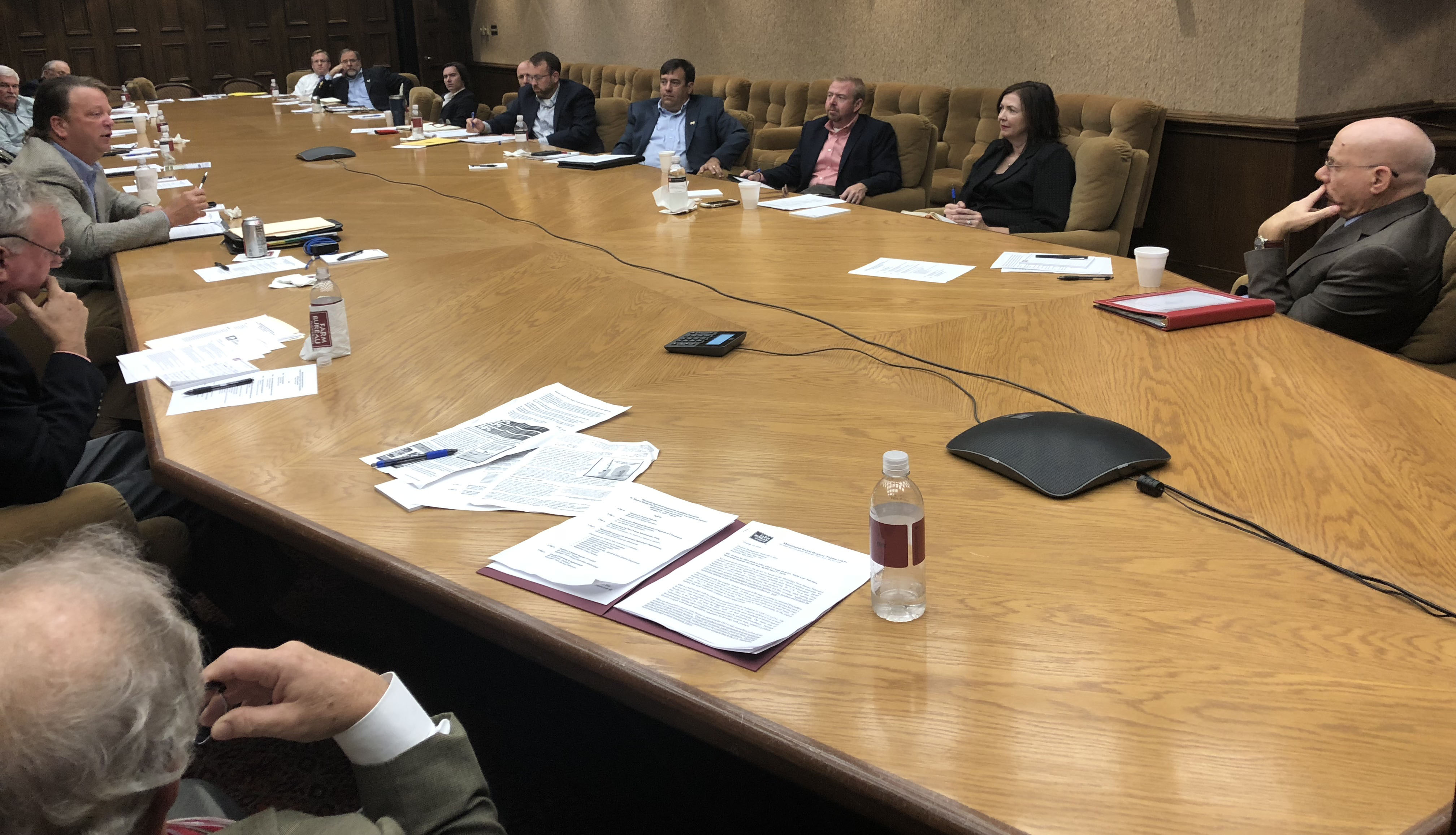 FDA round table discussion in Mississippi, group seated around large wooden table covered with papers