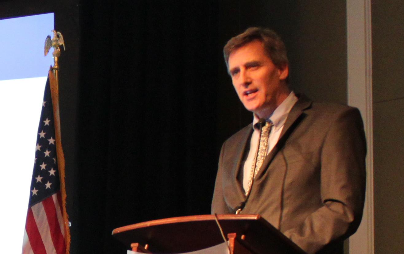 2019 GAC, Jason Hafemeister stands at podium next to screen with text "NAFTA and Public Opinion"