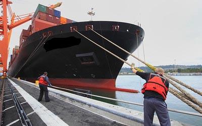 Cargo ship tying in at port