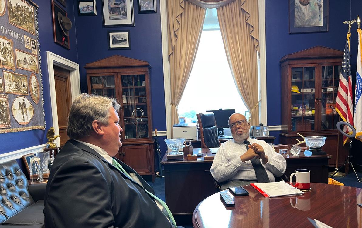 Farmer-Fly-In,-Marvin-Cochran-&-Rep-Benny-Thompson in an ornate office painted deep blue with art-filled walls and bookcases