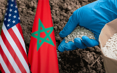 US & Moroccan Flags & Phosphate in Gloved Hand