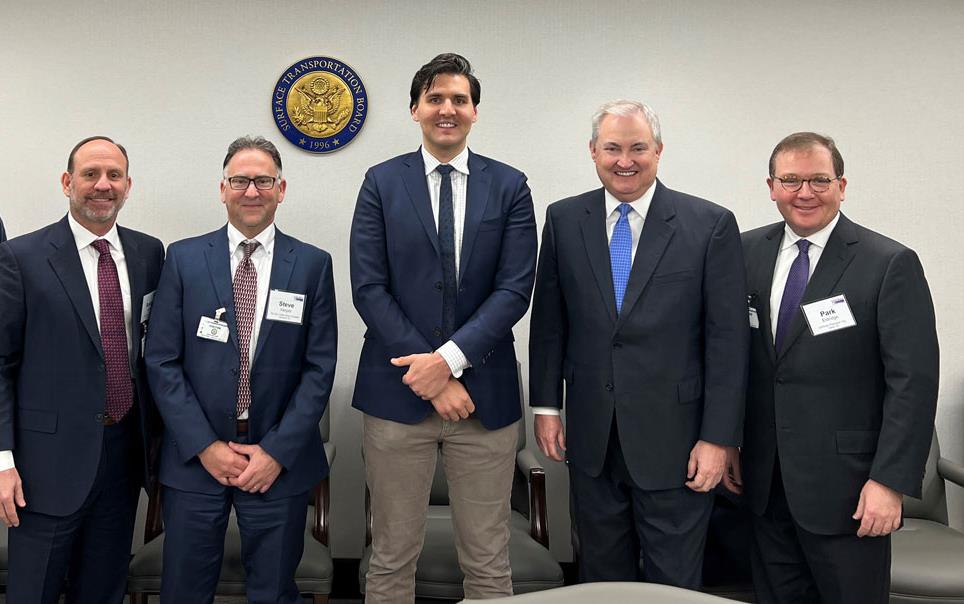 Mtg-with-STB-Patrick-Fuchs, group of men in business suits stand in a line