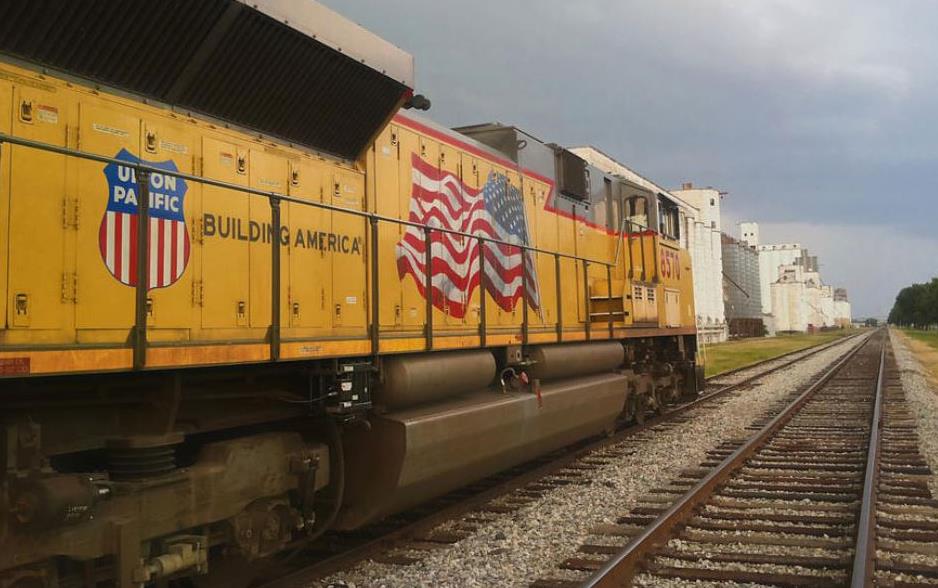 Yellow train cars with Union Pacific logo and American flag at grain bins in Katy, TX, Nathan-Little-photo