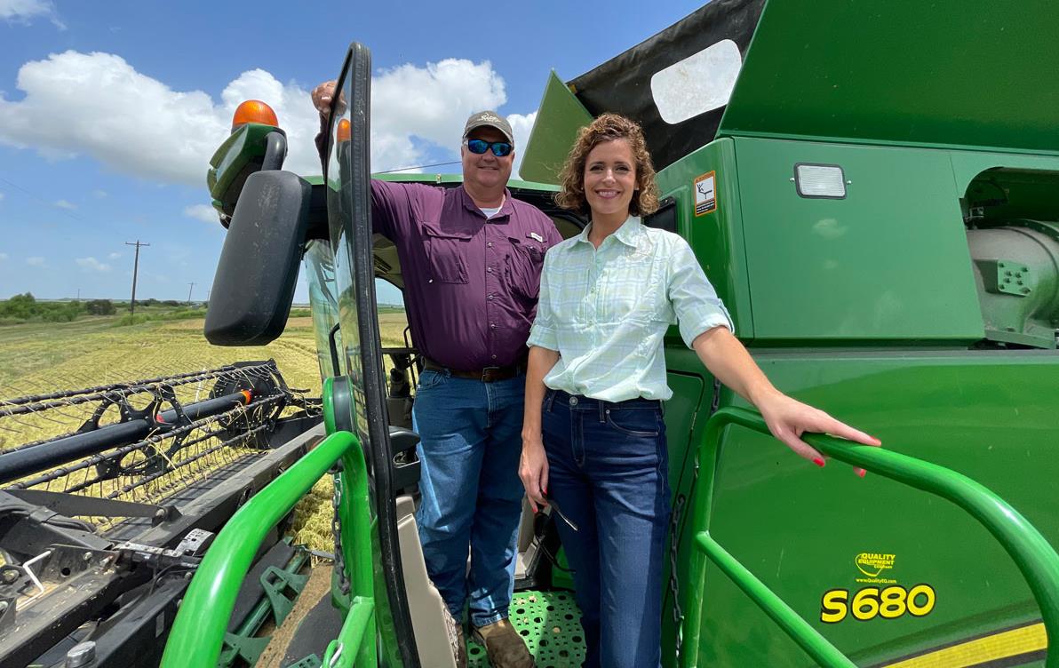 Rep-Julia-Letlow-&-Alan-Lawson stand at cab entrance of John Deere combine