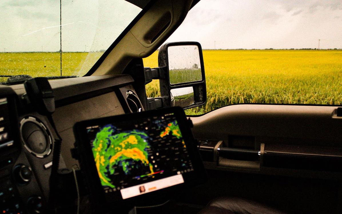 Storm-tracker-in truck cab next-to-mature-AR-rice-fields
