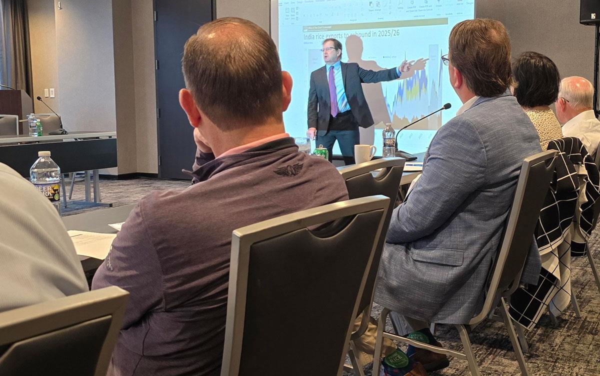 USDA Economist Seth Meyer in front of projection screen at fly-in presentation, audience seated around conference room tables