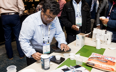 2025 Outlook, 6th Annual Quality Symposium, man prepping rice for sampling