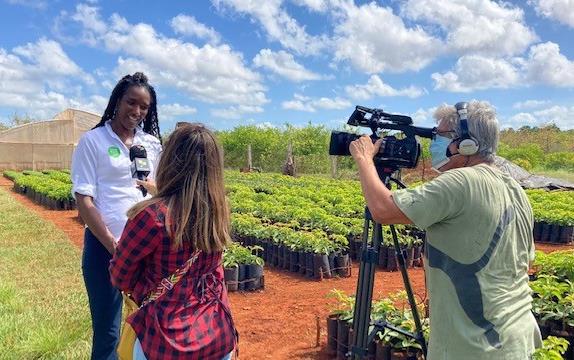 2022 Ag Tour of Cuba, A. Grigsby interviewed outside, woman holding microphone and man operating camera