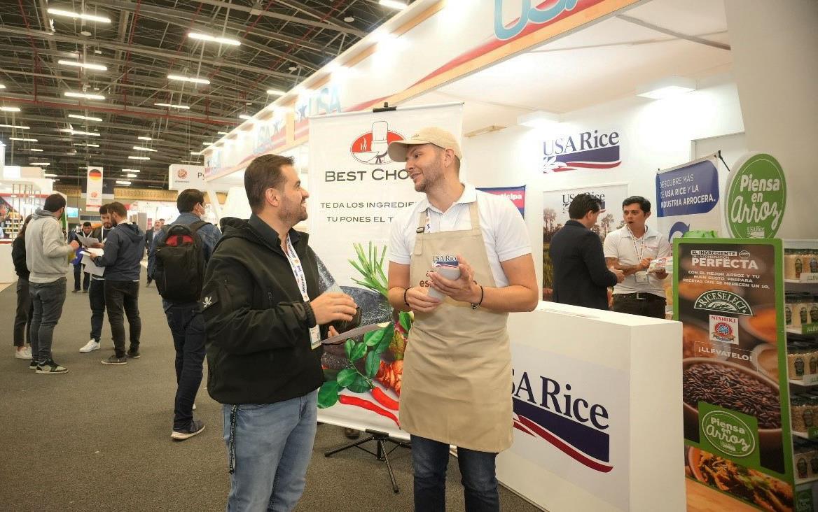 2022-Alimentec-Fair, groups of people talking both inside and outside the USAR booth