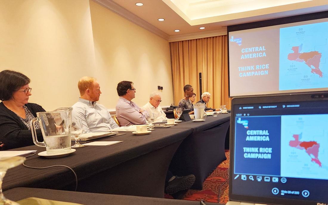 2024-IPPC-Mtg-in-Costa-Rica, people seated at conference room table watching slide show mirrored in computer monitor