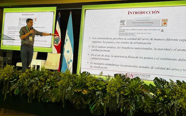 Dr. Alvaro Durand-Morat-on-stage in front of slideshow screen at-Convention-in-Honduras