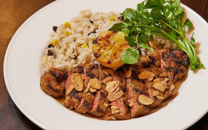 Plate of Hard Rock Cafe Lumberjack Steak & Rice with Lemon & Parsley Garnish