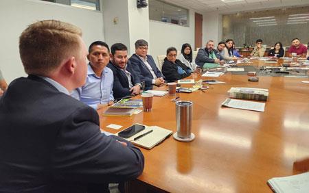 Jamison-Cruce-Talking-to-Cochran-Fellows seated around USAR conference table