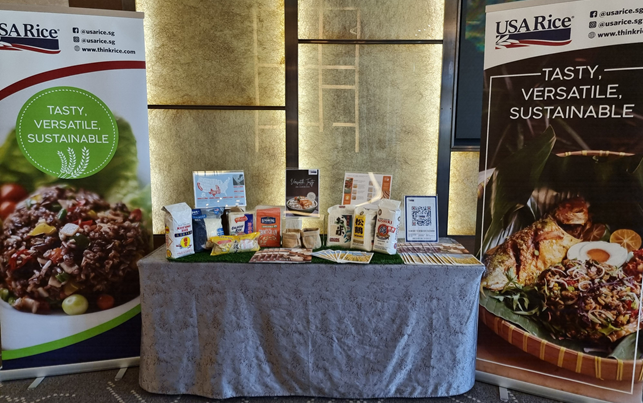 2022 World Gourmet Summitt table display with US rice products, flanked by two USA Rice posters