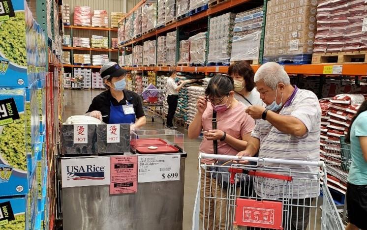 Taiwan Costco Promo, people stand near shopping cart, taste testing food samples