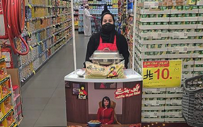 Woman wearing facemask staffs USAR Booth in Saudi Arabia grocery store