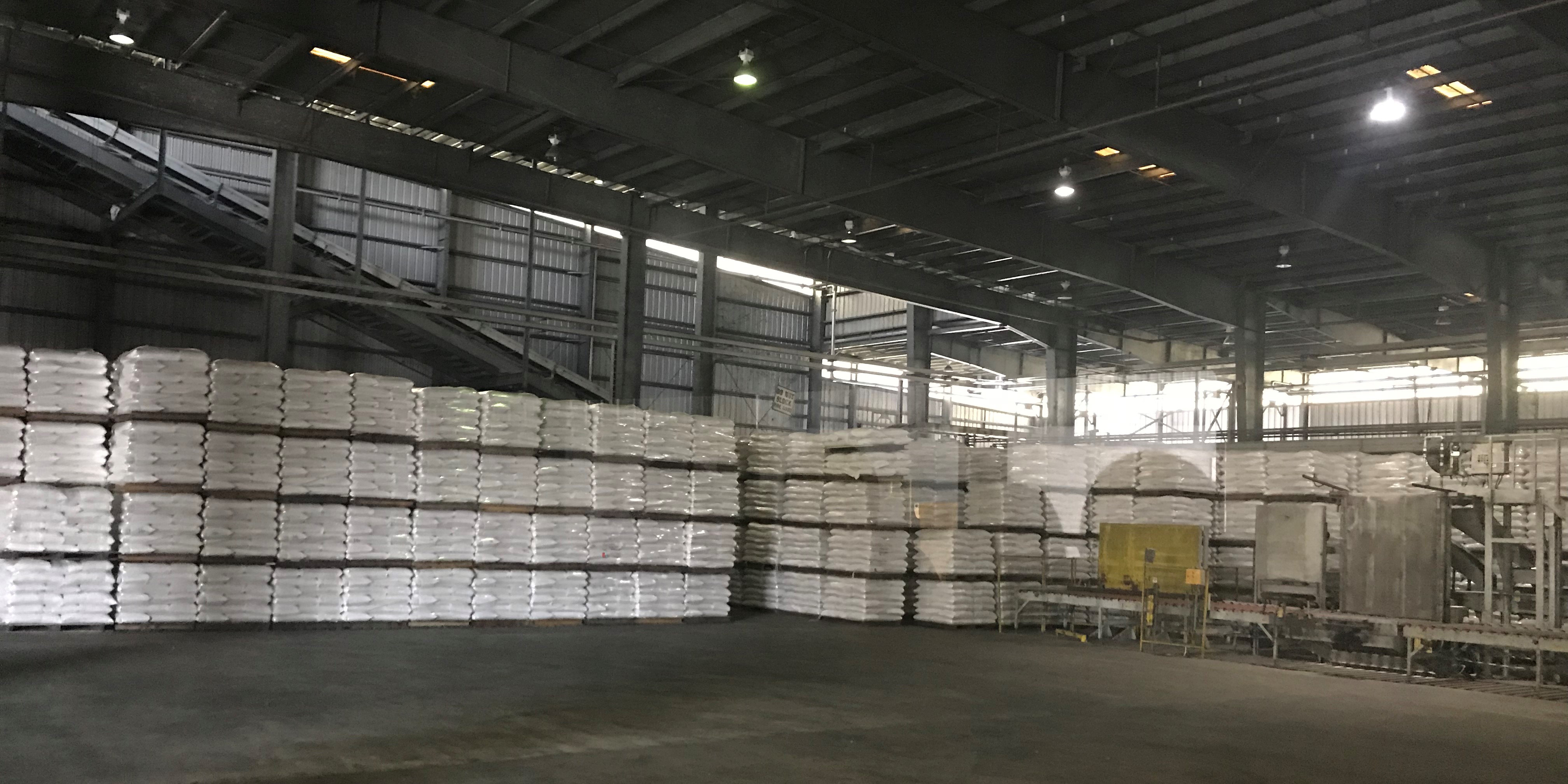 Warehouse full of bags of rice, stacked on pallets, ready to be shipped out